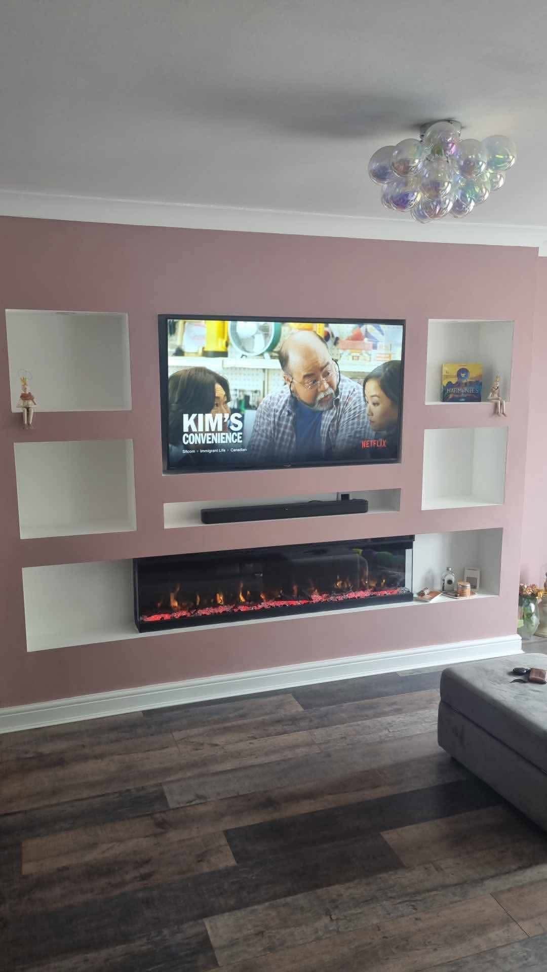 Pink Media wall with TV and electric fire